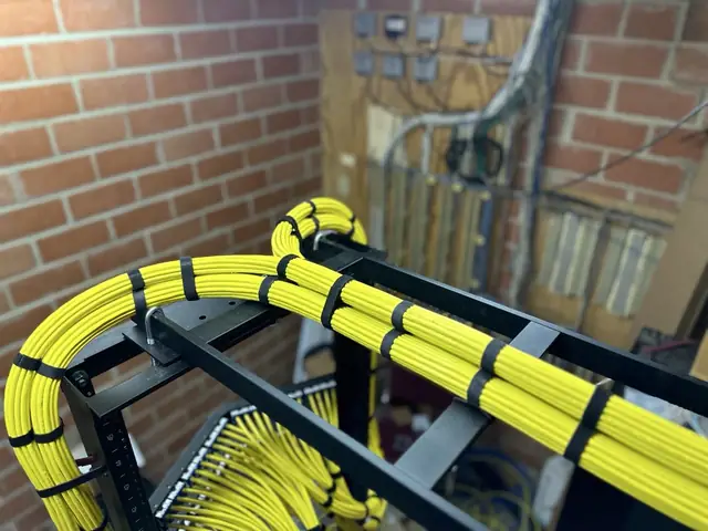 Yellow Cat6A bundle over open frame rack