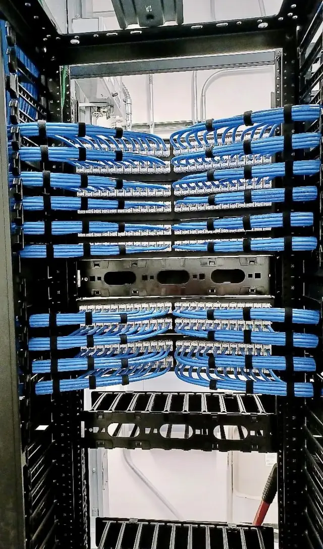 Vertical rack with blue Cat6 patch panels